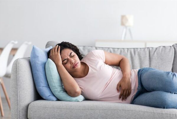 Female suffering from headache and menstruation pain