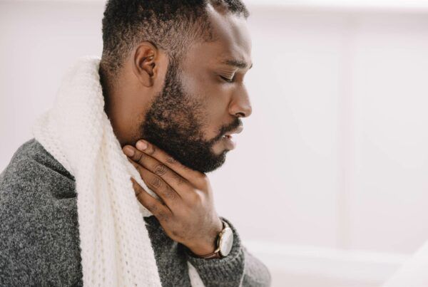 Male suffering from sore throat
