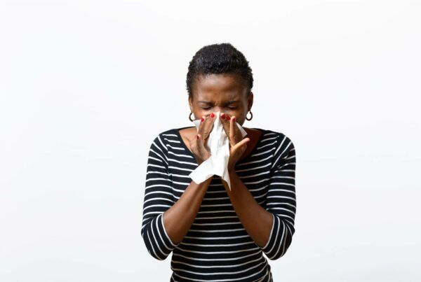 Female blowing her nose because of a cold